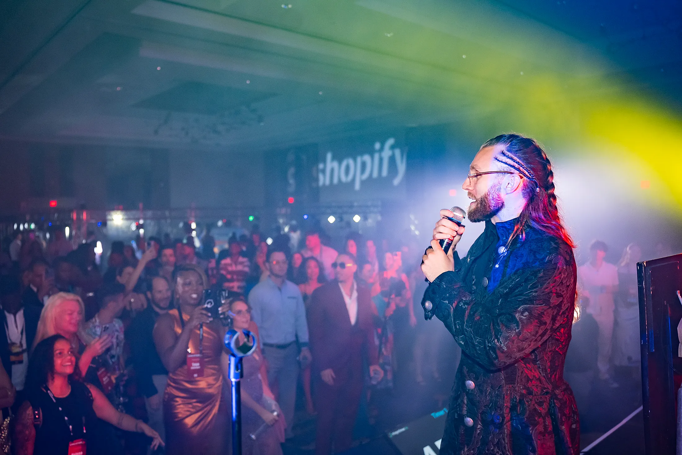A host firing up the crowd at the CreatorHub after-party